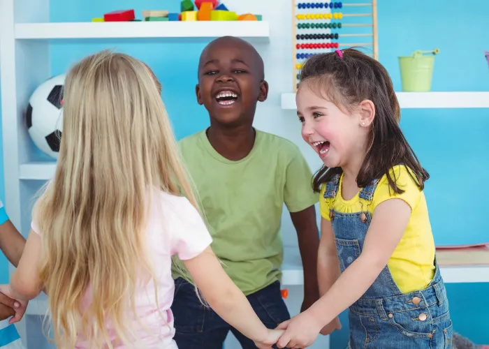 Happy kids holding hands together in the bedroom