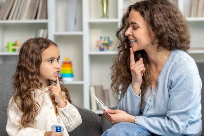 young girl doing speech and language therapy.