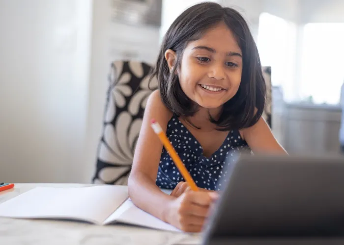 young girl using executive functioning to do homework.