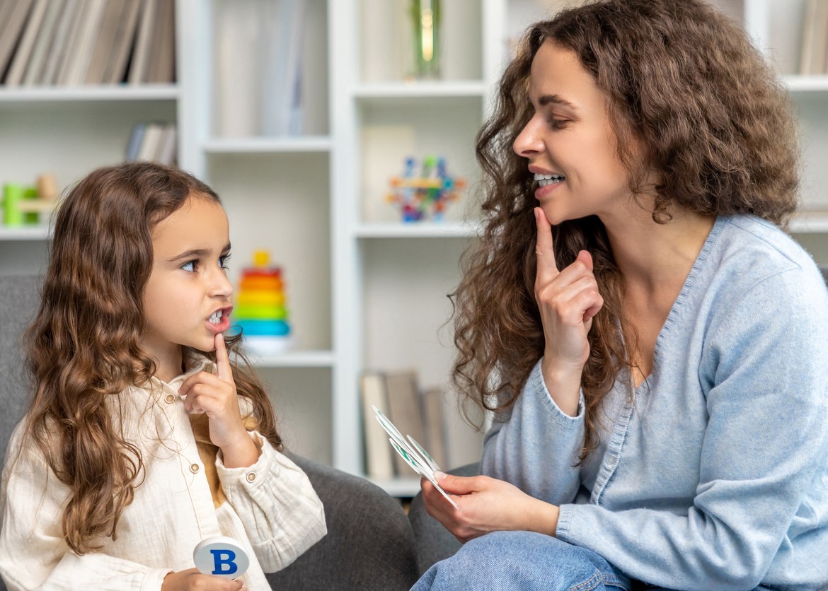 young girl doing speech and language therapy.